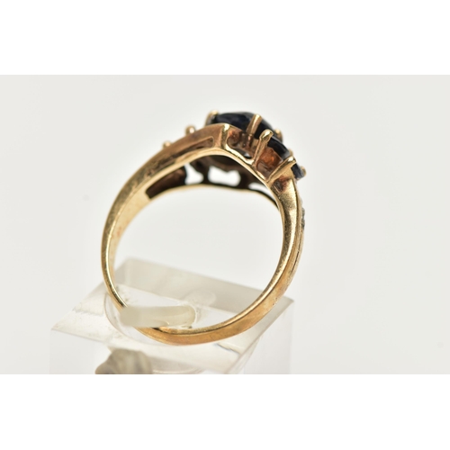 74 - A 9CT GOLD SAPPHIRE AND DIAMOND DRESS RING, set with an oval dark sapphire and marquise sapphire (on... 