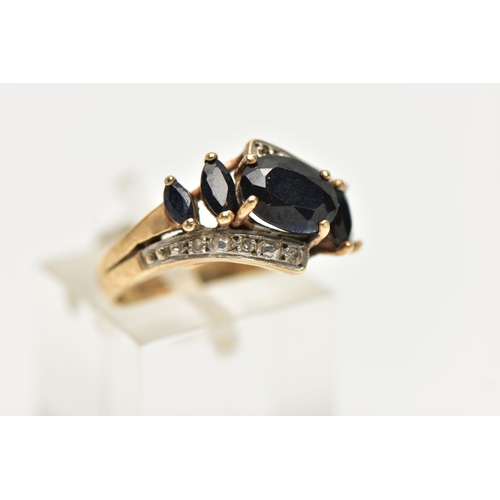 74 - A 9CT GOLD SAPPHIRE AND DIAMOND DRESS RING, set with an oval dark sapphire and marquise sapphire (on... 