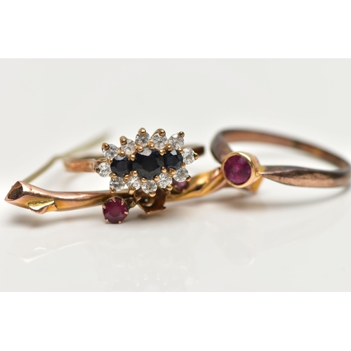 82 - TWO RINGS AND A BROOCH, the first a cluster ring set with three graduated circular cut blue sapphire... 