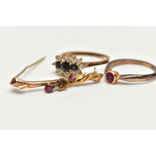 82 - TWO RINGS AND A BROOCH, the first a cluster ring set with three graduated circular cut blue sapphire... 