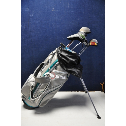 1054 - GOLF EQUIPMENT comprising a Ram golf bag containing seven golf clubs, Odyssey white hot putter, Zebr... 