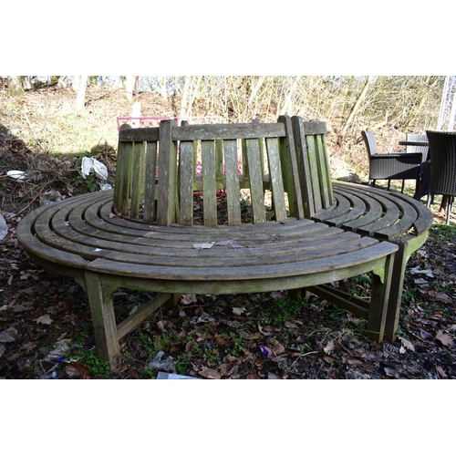 902 - A WEATHERED TEAK TREE BENCH, overall diameter 220cm x inner diameter 100cm (condition:- losses to be... 