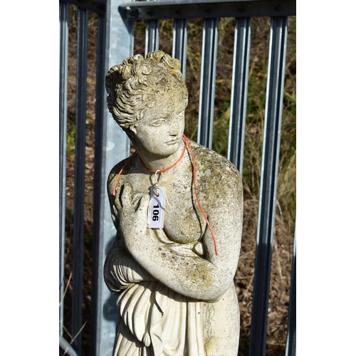 906 - A WEATHERED COMPOSITE GARDEN FIGURE, of a scantily clad lady in flowing robes, on a separate plinth,... 