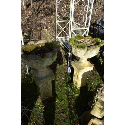 913 - A PAIR OF WEATHERED ACANTHUS LEAF PLANTERS, on a separate plinth, diameter 48cm x height 89cm x heig... 