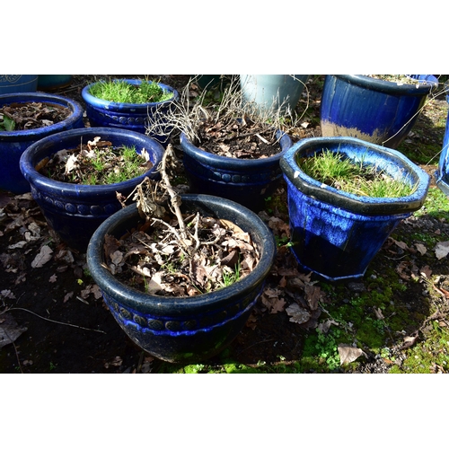 921 - FOUR MATCHING CIRCULAR BLUE GLAZED PLANTERS, diameter 40cm x height 26cm, and two other blue glazed ... 