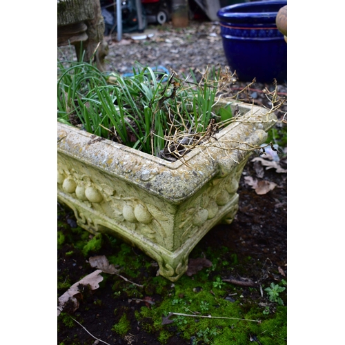 923 - A WEATHERED COMPOSITE RECTANGULAR PLANTER, with floral decoration, length 67cm