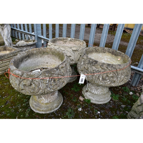 927 - A SET OF THREE WEATHERED COMPOSITE PLANTERS, on separate bases, diameter 45cm x height 45cm (conditi... 