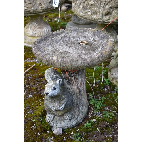 928 - A WEATHERED COMPOSITE FIGURAL BIRD BATH, circular top, on a loose base depicting a putto, diameter 3... 