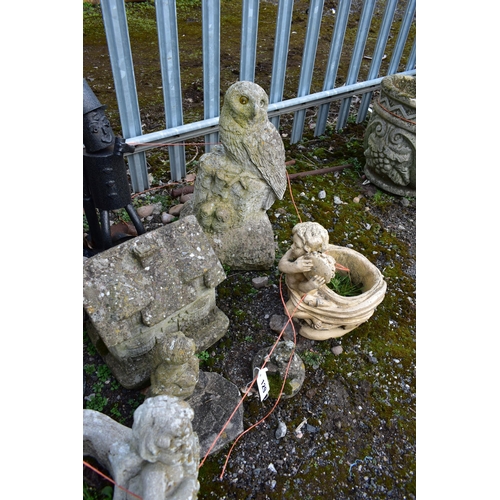 929 - A SELECTION OF WEATHERED COMPOSITE GARDEN ORGAMENTS, to include a tulip shaped urn, figural owl, tha... 