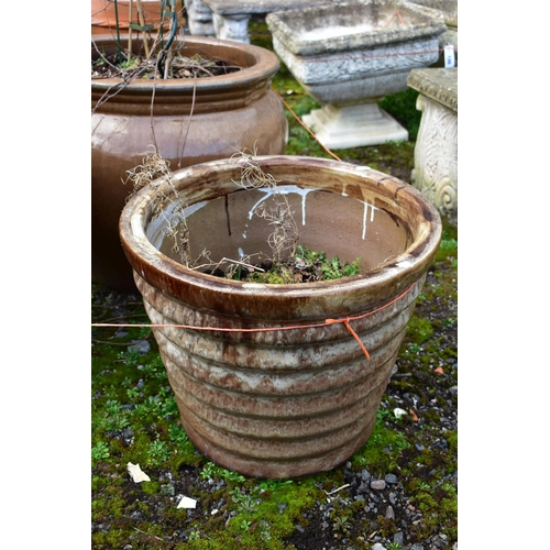 933 - A BROWN GLAZED CIRCULAR PLANT PLANTER, of a ribbed tapered design, diameter 47cm x height 40cm, and ... 