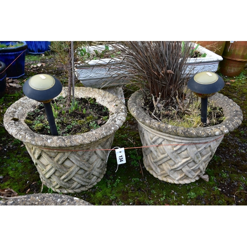 934 - A PAIR OF WEATHERED COMPOSITE CIRCULAR TAPERED PLANTERS, with a lattice design, diameter 53cm x heig... 