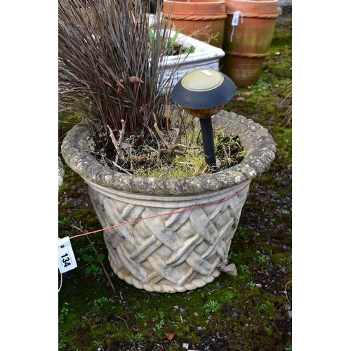 934 - A PAIR OF WEATHERED COMPOSITE CIRCULAR TAPERED PLANTERS, with a lattice design, diameter 53cm x heig... 