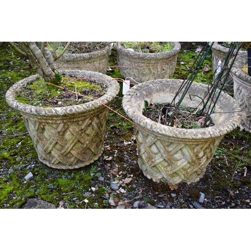 935 - A PAIR OF WEATHERED COMPOSITE CIRCULAR TAPERED PLANTERS, with a lattice design, diameter 53cm x heig... 