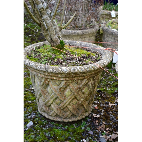 935 - A PAIR OF WEATHERED COMPOSITE CIRCULAR TAPERED PLANTERS, with a lattice design, diameter 53cm x heig... 