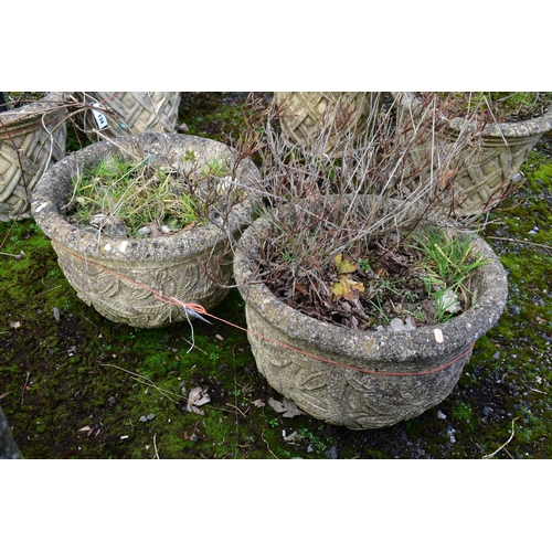 936 - A PAIR OF WEATHERED COMPOSITE CIRCULAR PLANTERS, with a floral design, diameter 53cm x height 36cm (... 