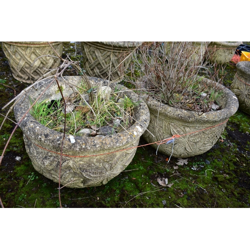 936 - A PAIR OF WEATHERED COMPOSITE CIRCULAR PLANTERS, with a floral design, diameter 53cm x height 36cm (... 