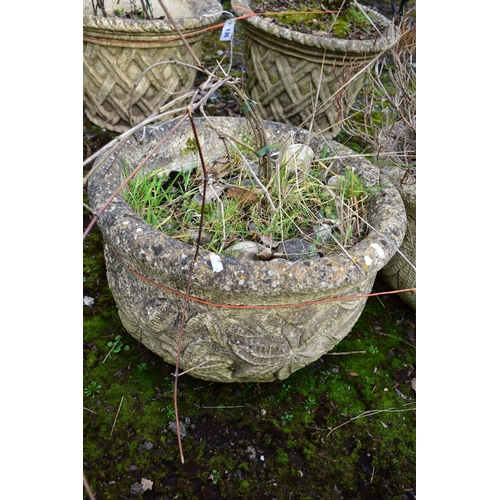 936 - A PAIR OF WEATHERED COMPOSITE CIRCULAR PLANTERS, with a floral design, diameter 53cm x height 36cm (... 