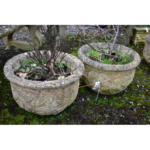 939 - A PAIR OF WEATHERED COMPOSITE CIRCULAR PLANTERS, with a floral design, diameter 53cm x height 36cm (... 