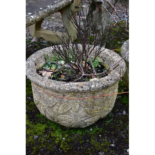 939 - A PAIR OF WEATHERED COMPOSITE CIRCULAR PLANTERS, with a floral design, diameter 53cm x height 36cm (... 