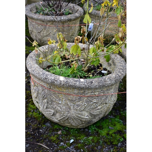 940 - A PAIR OF WEATHERED COMPOSITE CIRCULAR PLANTERS, with a floral design, diameter 53cm x height 36cm (... 