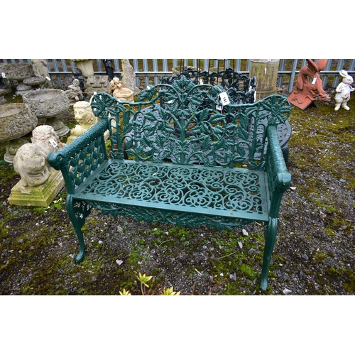 941 - A VICTORIAN STYLE HEAVY CAST IRON GARDEN BENCH, with leaf and vines shaped back, rams head armrest, ... 