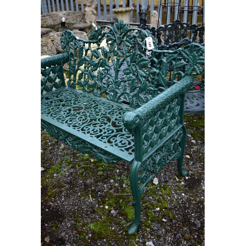 941 - A VICTORIAN STYLE HEAVY CAST IRON GARDEN BENCH, with leaf and vines shaped back, rams head armrest, ... 