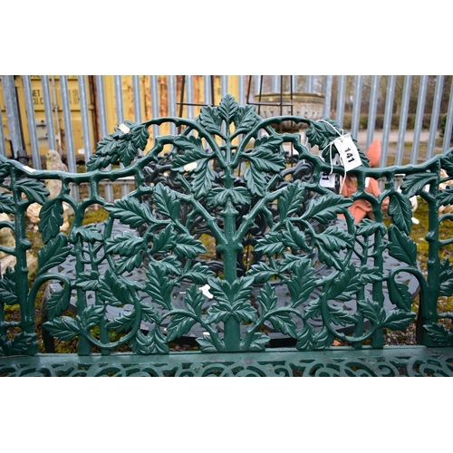 941 - A VICTORIAN STYLE HEAVY CAST IRON GARDEN BENCH, with leaf and vines shaped back, rams head armrest, ... 