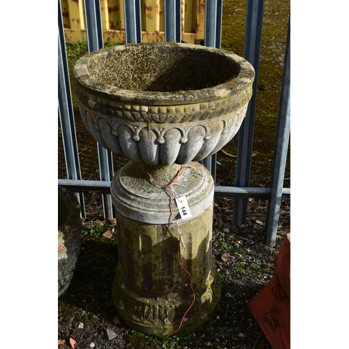 944 - A WEATHERED COMPOSITE CAMPAGNA GARDEN URN, on a separate reeded pillar, diameter 55cm x height 99cm ... 