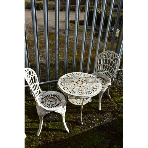 946 - A PAINTED CAST IRON CIRCULAR GARDEN TABLE, diameter 61cm x height 55cm, and two chairs (condition:-a... 