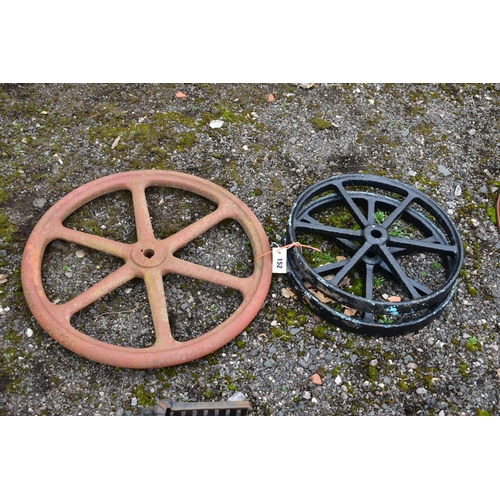 952 - A  CAST IRON MACHINE PULL WHEEL, diameter 63cm, along with a pair of  black painted kart wheels, dia... 