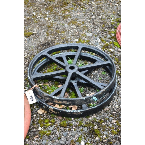 952 - A  CAST IRON MACHINE PULL WHEEL, diameter 63cm, along with a pair of  black painted kart wheels, dia... 