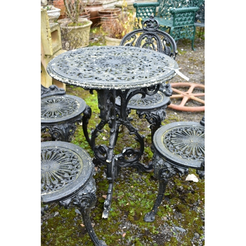 953 - A PAINTED CAST IRON CIRCULAR GARDEN TABLE, diameter 59cm x height 70cm and four chairs (condition:-o... 