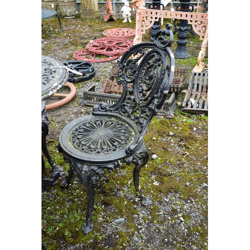 953 - A PAINTED CAST IRON CIRCULAR GARDEN TABLE, diameter 59cm x height 70cm and four chairs (condition:-o... 