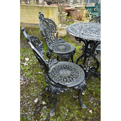 953 - A PAINTED CAST IRON CIRCULAR GARDEN TABLE, diameter 59cm x height 70cm and four chairs (condition:-o... 