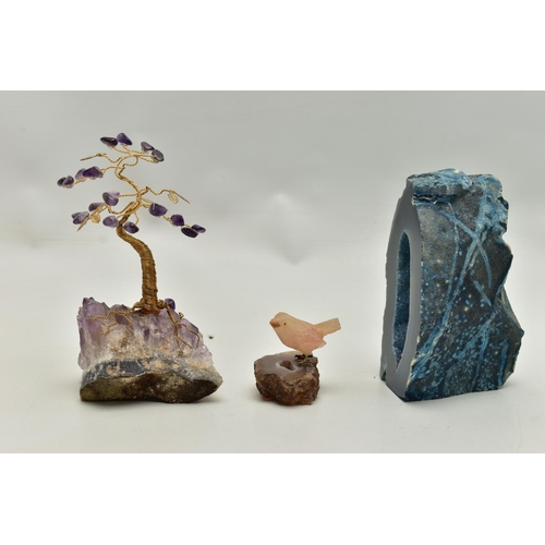 104 - THREE MINERAL SPECIMEMS, the first an amethyst geode, fashioned with a yellow metal wire tree suspen... 