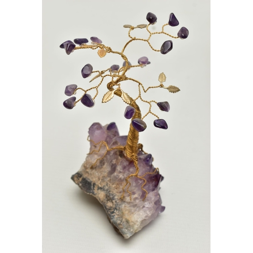 104 - THREE MINERAL SPECIMEMS, the first an amethyst geode, fashioned with a yellow metal wire tree suspen... 