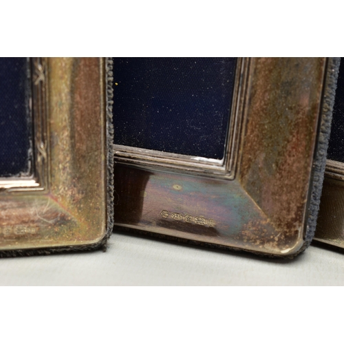 153 - A SET OF FOUR ELIZABETH II SILVER MOUNTED EASEL BACK PHOTOGRAPH FRAMES OF RECTANGULAR FORM, with a r... 