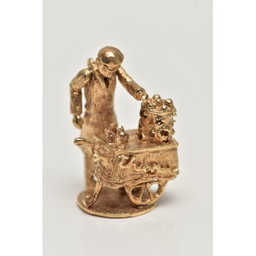 18 - A 9CT GOLD CHARM, yellow gold kinetic charm of a man at a cart, hallmarked 9ct London, approximate g... 