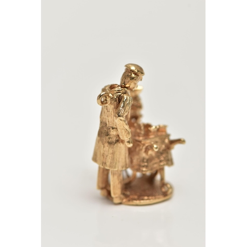 18 - A 9CT GOLD CHARM, yellow gold kinetic charm of a man at a cart, hallmarked 9ct London, approximate g... 