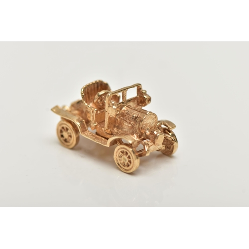 21 - A 9CT GOLD CHARM,  yellow gold charm of a car with moving wheels, hallmarked 9ct London, approximate... 