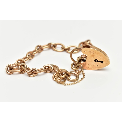 28 - A 9CT GOLD BRACELET, oval link chain fitted with a spring clasp, fitted with a heart padlock clasp w... 