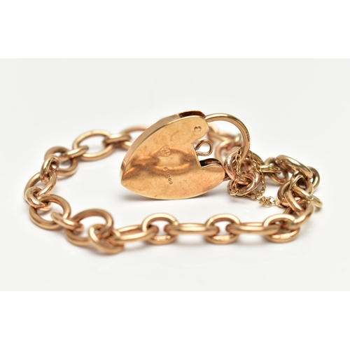 28 - A 9CT GOLD BRACELET, oval link chain fitted with a spring clasp, fitted with a heart padlock clasp w... 