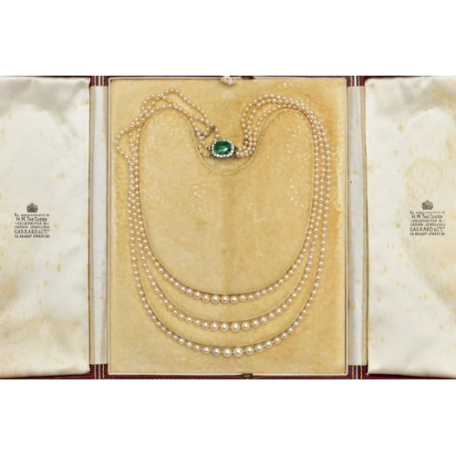 4 - A CULTURED PEARL NECKLACE WITH EMERALD AND DIAMOND CLASP, designed as three graduating rows of cultu... 