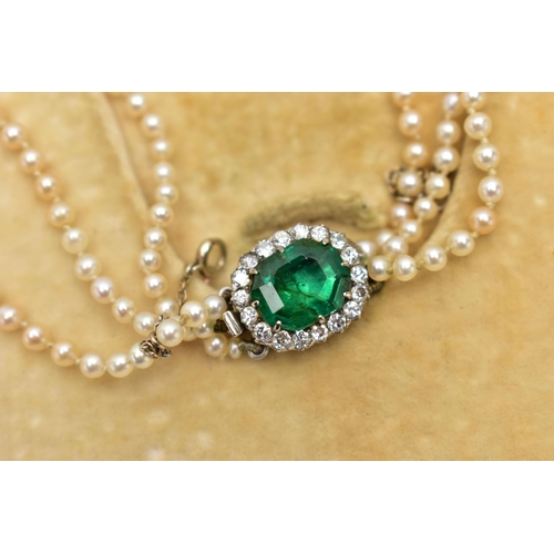 4 - A CULTURED PEARL NECKLACE WITH EMERALD AND DIAMOND CLASP, designed as three graduating rows of cultu... 