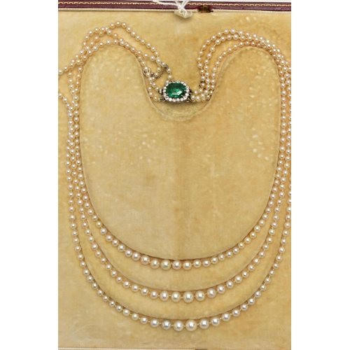 4 - A CULTURED PEARL NECKLACE WITH EMERALD AND DIAMOND CLASP, designed as three graduating rows of cultu... 