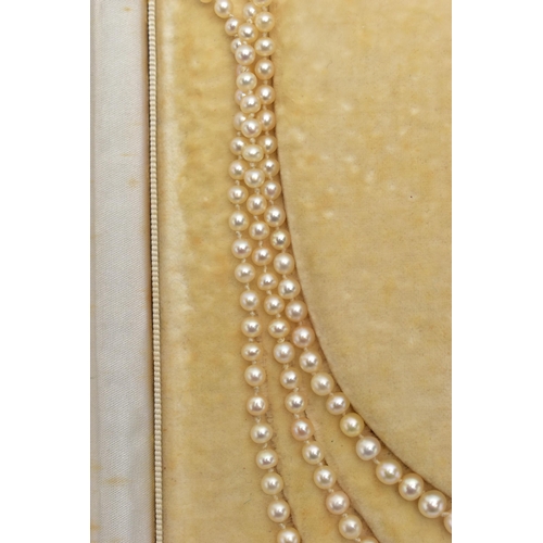 4 - A CULTURED PEARL NECKLACE WITH EMERALD AND DIAMOND CLASP, designed as three graduating rows of cultu... 