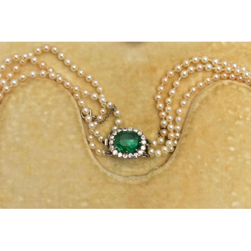 4 - A CULTURED PEARL NECKLACE WITH EMERALD AND DIAMOND CLASP, designed as three graduating rows of cultu... 