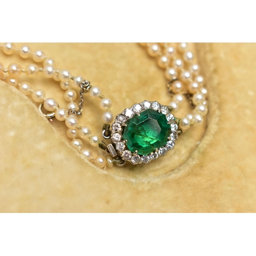 4 - A CULTURED PEARL NECKLACE WITH EMERALD AND DIAMOND CLASP, designed as three graduating rows of cultu... 