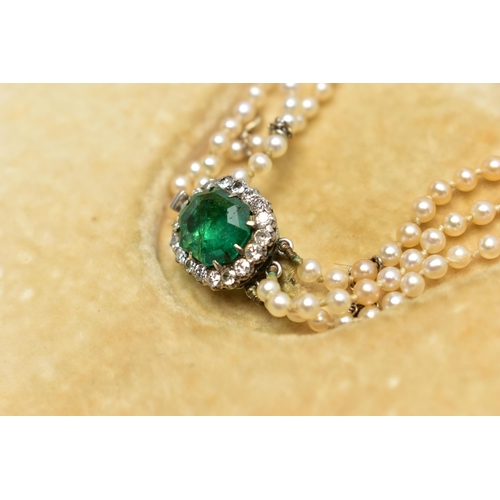 4 - A CULTURED PEARL NECKLACE WITH EMERALD AND DIAMOND CLASP, designed as three graduating rows of cultu... 