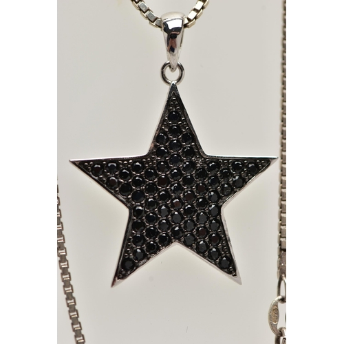 46 - A WHITE METAL BLACK CUBIC ZIRCONIA SET PENDANT NECKLACE, the star pendant pave set with circular cut... 